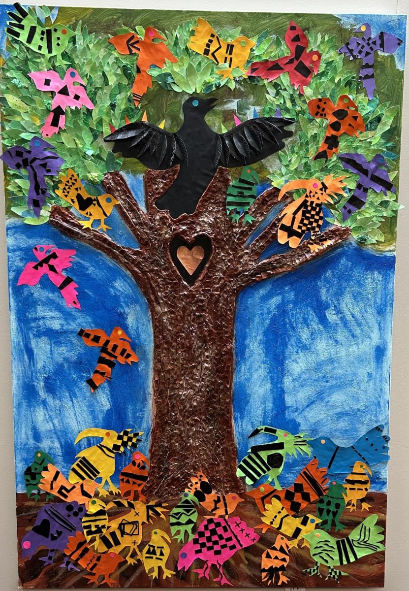 Beautiful Blackbird Collaborative Art Inspired by American Author Ashley Bryan -- 
This collaborative mixed media piece was inspired by the book BEAUTIFUL BLACKBIRD by author and artist Ashley Bryan. It was made by the PK-3rd grade students. PK/K students created textured paper for the leaves. 1st & 3rd grades created collage birds. 2nd Grade hand cut leaves from texture paper. All students in grades 1-3 added bark to the tree using clay. Each textured mark on the tree trunk is created with fingerprints from our students. 